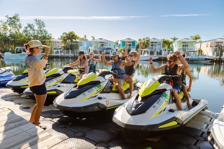 A group of people on jetski with instructor.