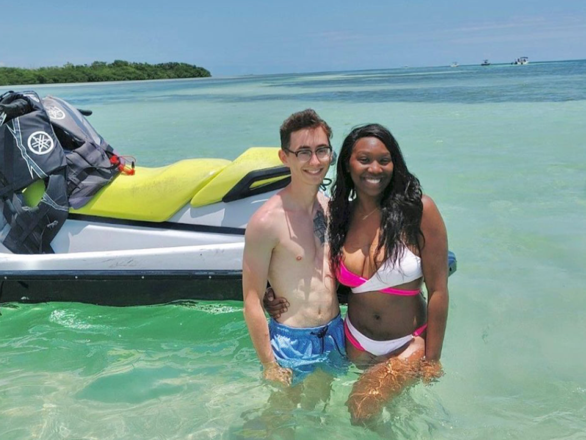 a person standing next to a body of water