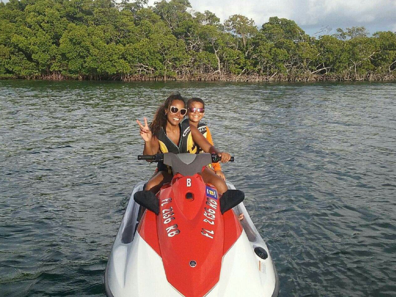 a person standing next to a body of water