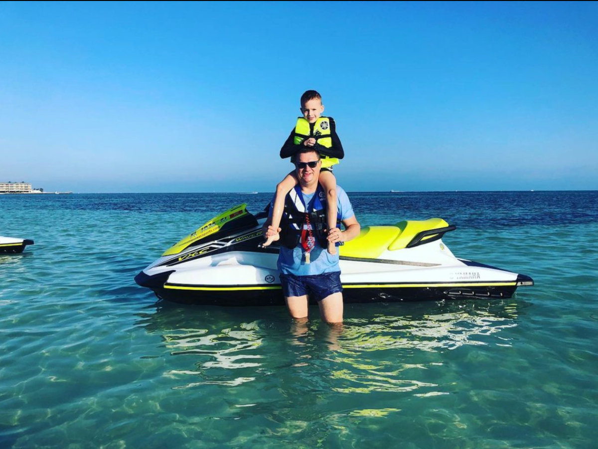 a person riding on the back of a boat in the water