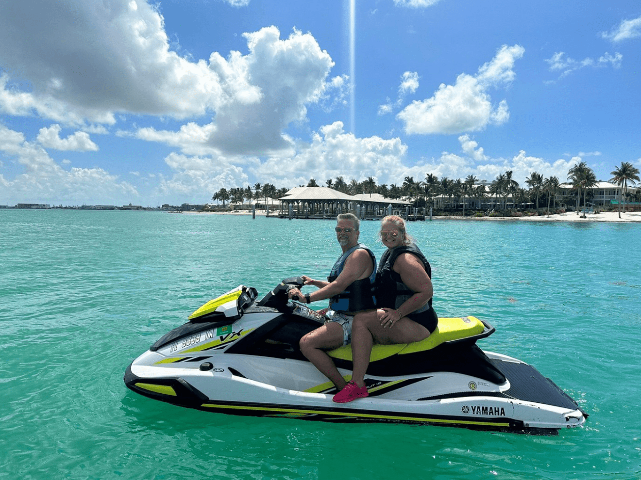 a person riding on the back of a boat in a body of water