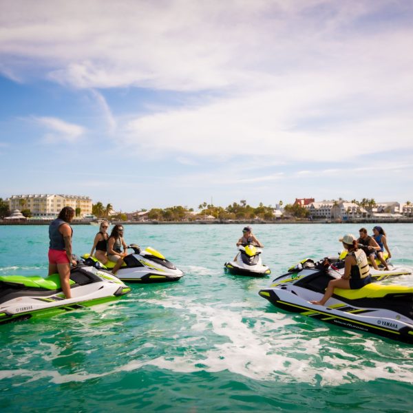 a group of people riding on the back of a jet ski in the water