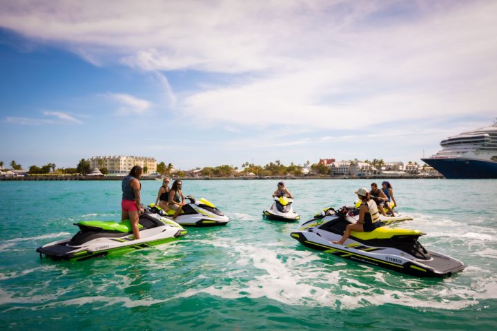 a group of people riding on the back of a jet ski in the water